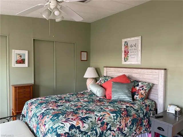 Bedroom featuring ceiling fan and a closet