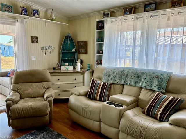 Living area featuring crown molding and wood finished floors