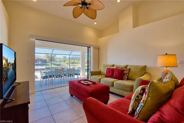 Living room featuring a sunroom, high vaulted ceiling, tile patterned floors, ceiling fan, and recessed lighting