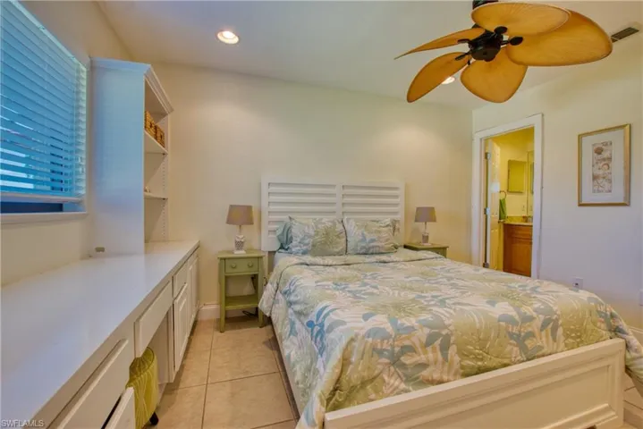 Bedroom featuring light tile patterned flooring, connected bathroom, ceiling fan, and recessed lighting