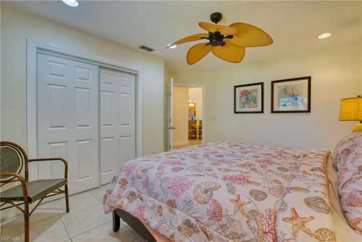 Bedroom featuring recessed lighting, light tile patterned flooring, a closet, and ceiling fan