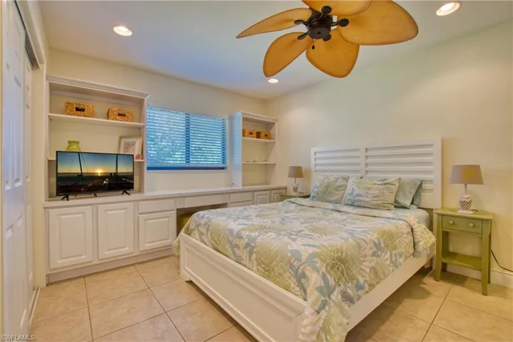Bedroom with light tile patterned flooring, recessed lighting, and ceiling fan