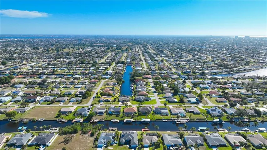 Aerial overview of property's location with a large body of water and nearby suburban area