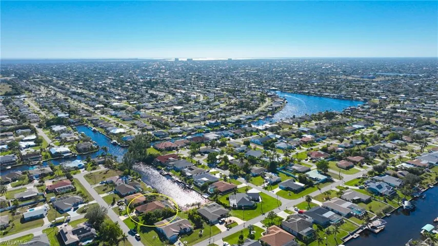 View of property location with a large body of water and nearby suburban area