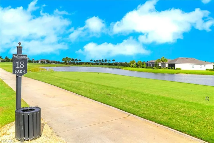 View of property's community featuring a water view and a lawn