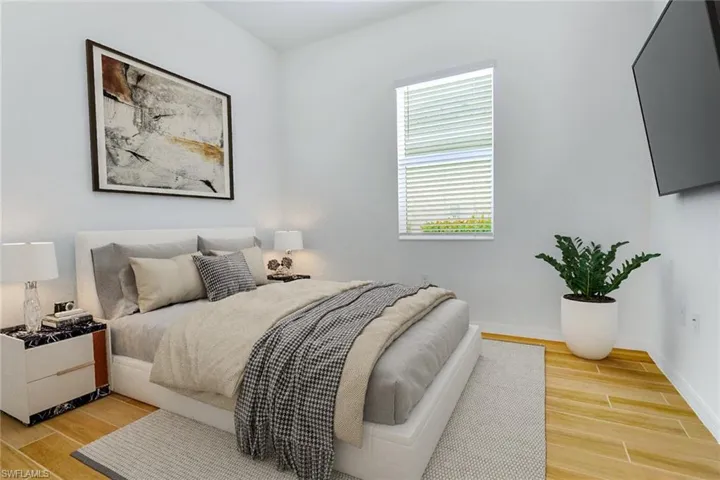Bedroom featuring wood tiled floors and baseboards