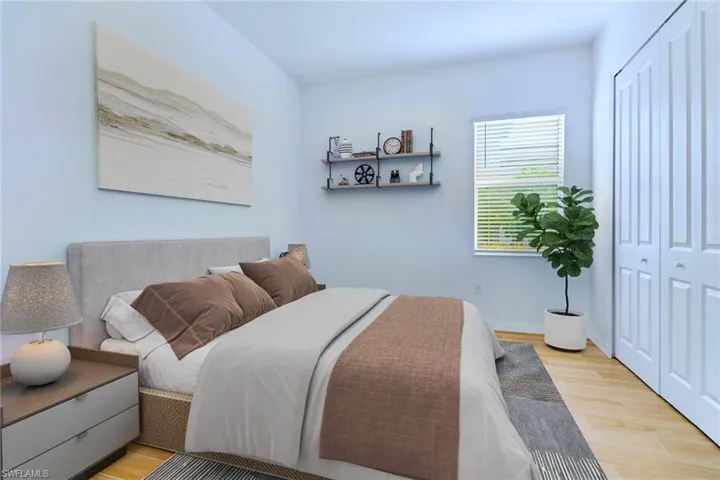 Bedroom with light wood-style flooring and a closet