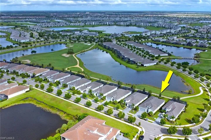View of property location featuring a nearby body of water, a local golf course, and nearby suburban area