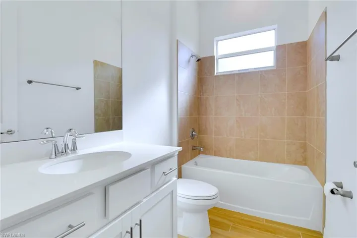 Full bathroom featuring vanity, bathing tub / shower combination, and light wood-type flooring