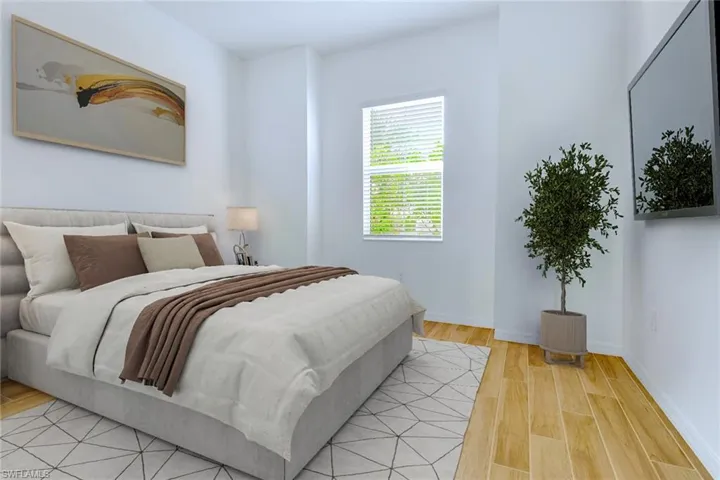 Bedroom featuring light wood-style flooring and baseboards
