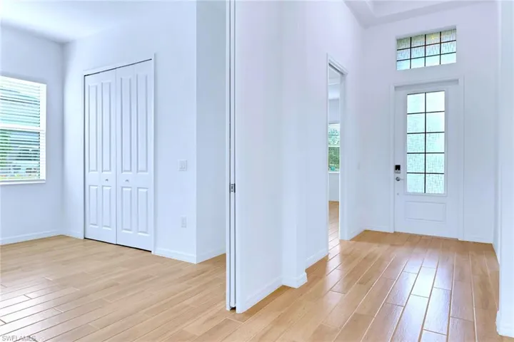 Entrance foyer featuring light wood-style floors