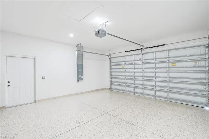 Garage with electric panel and a garage door opener