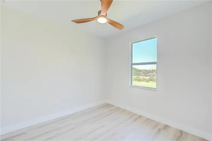 Bedroom featuring ceiling fan and wood finished floors