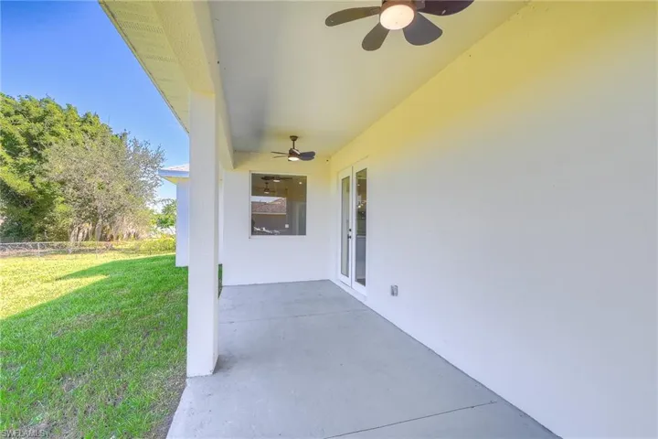 View of patio with ceiling fan and french doors