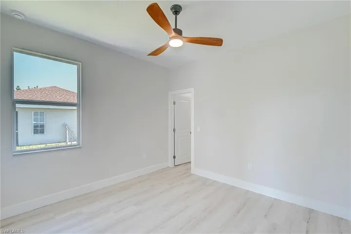 Spare room featuring light wood-style floors and a ceiling fan
