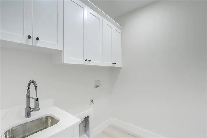 Laundry area featuring electric dryer hookup, cabinet space, and hookup for a washing machine