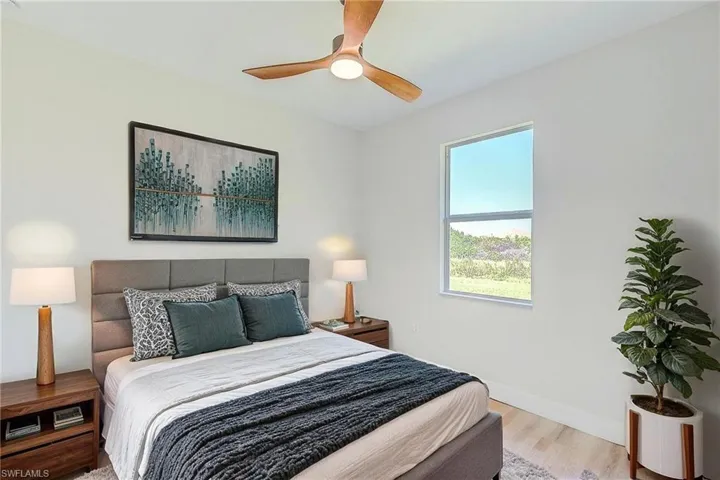 Bedroom featuring wood finished floors and a ceiling fan. Virtual Staged