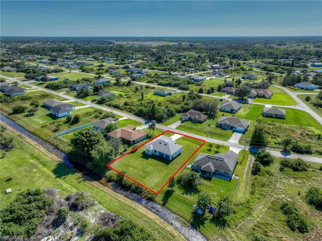 Aerial view of residential area featuring property boundaries highlighted