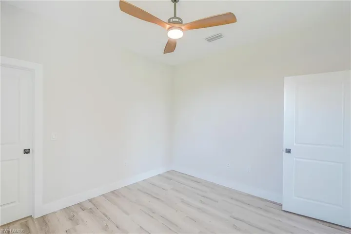 bedroom with light wood-style floors and ceiling fan