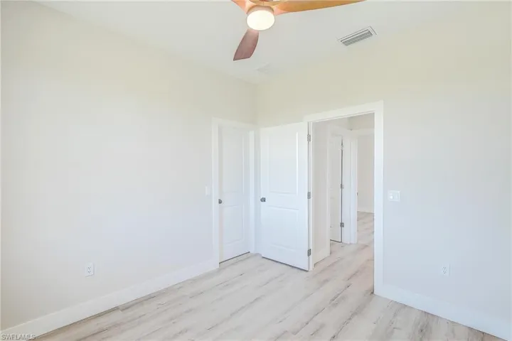 Spare room with light wood-style flooring and a ceiling fan