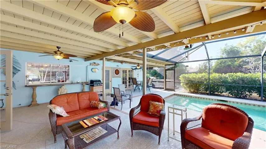 View of patio / terrace featuring an outdoor pool, a sunroom, glass enclosure, and ceiling fan