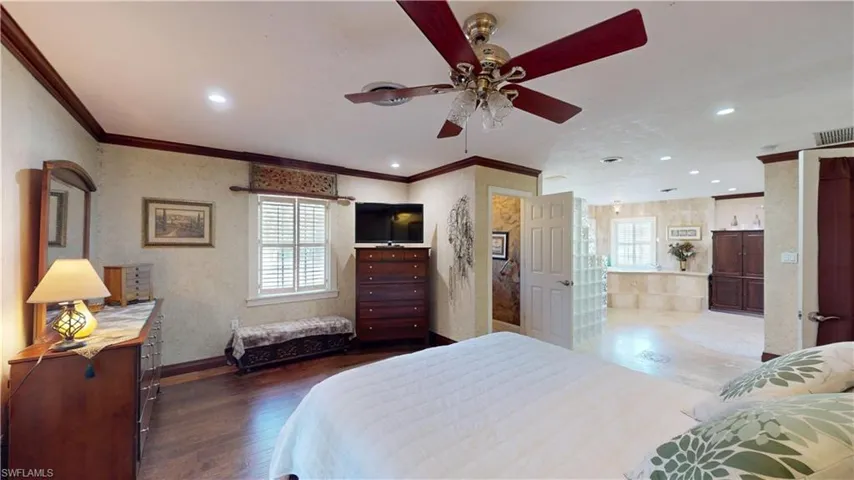 Bedroom with ornamental molding, recessed lighting, dark wood-style flooring, and a ceiling fan