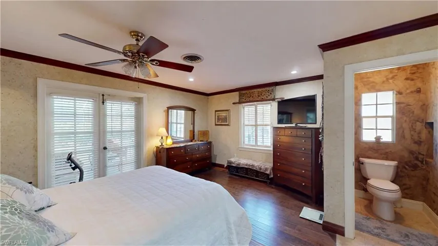 Bedroom featuring ornamental molding, dark wood-type flooring, a ceiling fan, access to exterior, and wallpapered walls