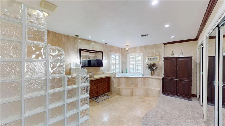 Full bathroom featuring a garden tub, vanity, recessed lighting, and walk in shower