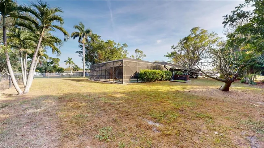View of yard with a lanai and a sunroom