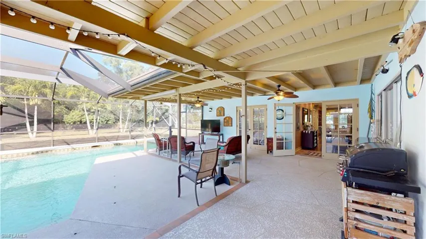 View of patio featuring a ceiling fan, a lanai, an outdoor pool, and a sunroom