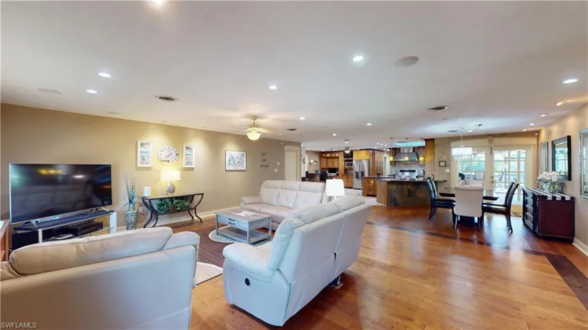 Living room with light wood-type flooring, recessed lighting, and a ceiling fan