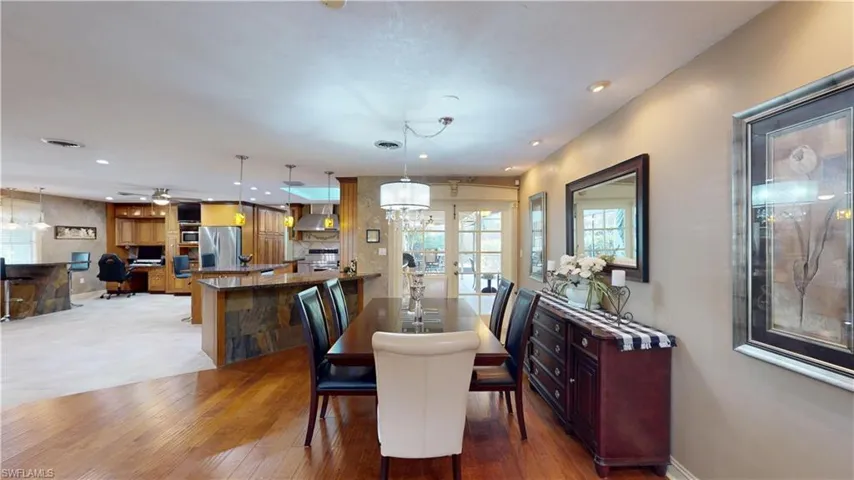 Dining space featuring recessed lighting, light wood-type flooring, and a chandelier