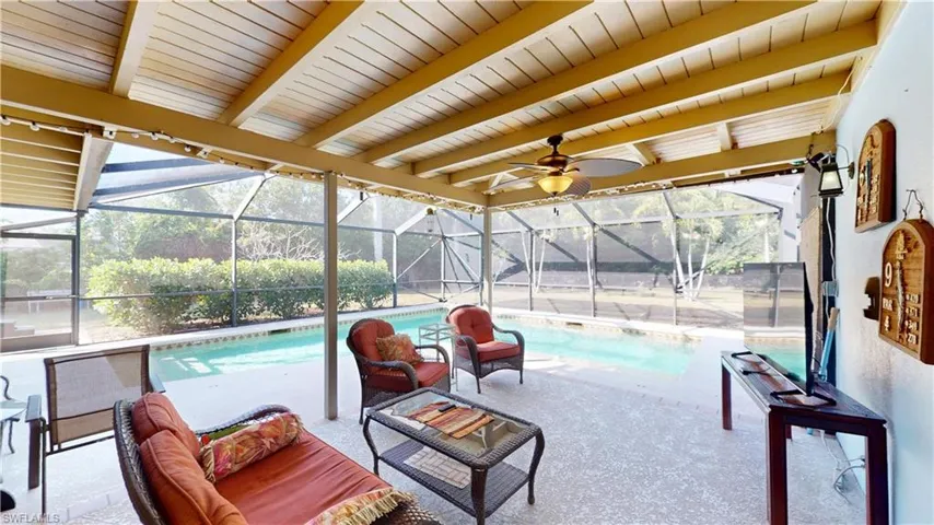 Swimming pool featuring a lanai, a sunroom, and a patio