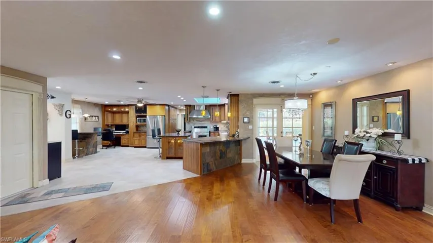 Dining room featuring light wood-type flooring and recessed lighting