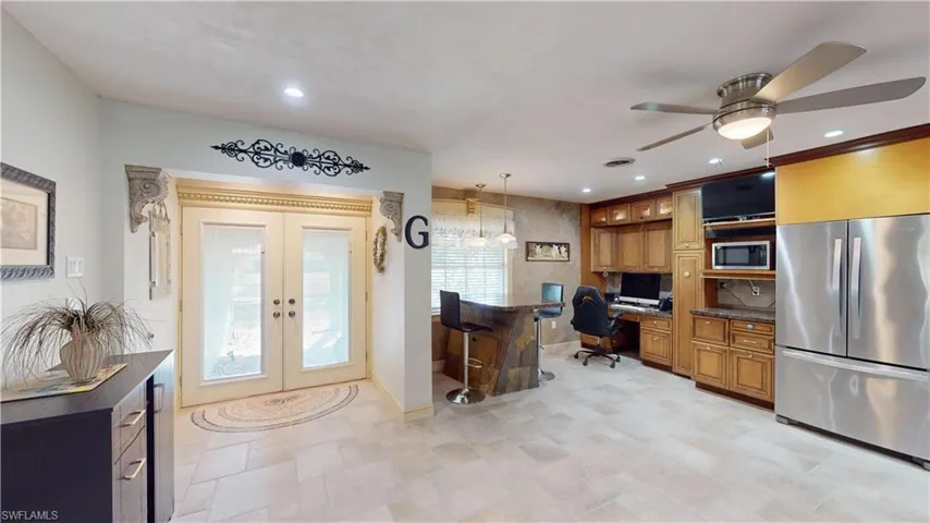 Home office with built in study area, french doors, a ceiling fan, and recessed lighting