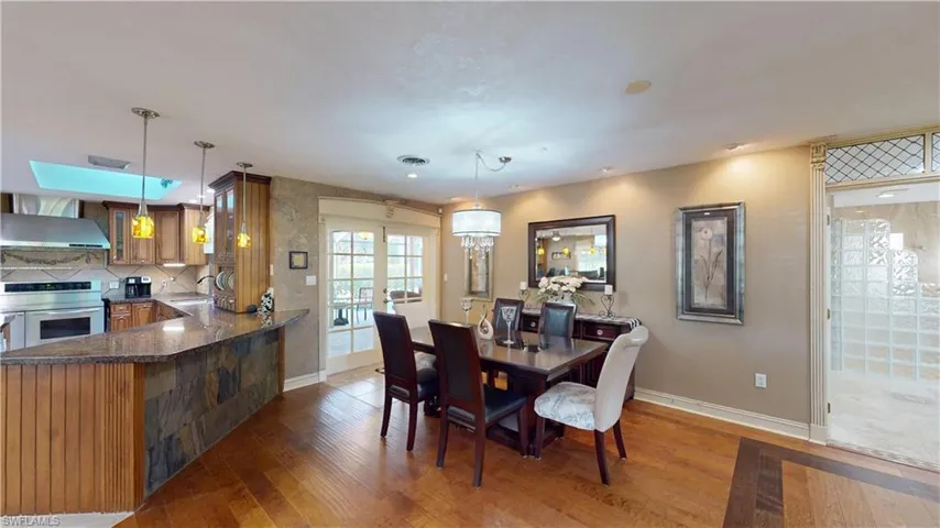 Dining room featuring light wood-style flooring and french doors