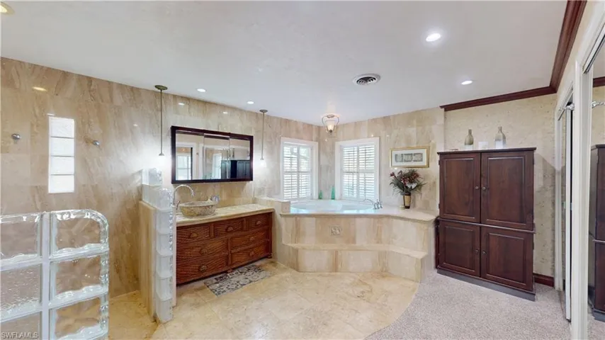 Bathroom with a garden tub, vanity, a walk in shower, and recessed lighting