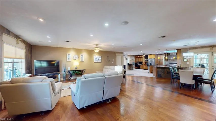 Living area featuring light wood-style floors, recessed lighting, and a ceiling fan