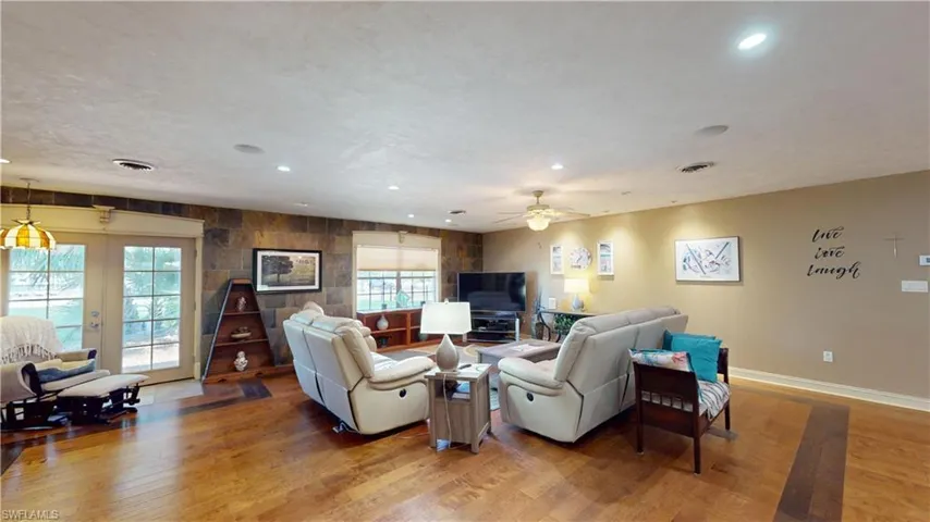 Living room featuring hardwood / wood-style flooring, recessed lighting, and a ceiling fan