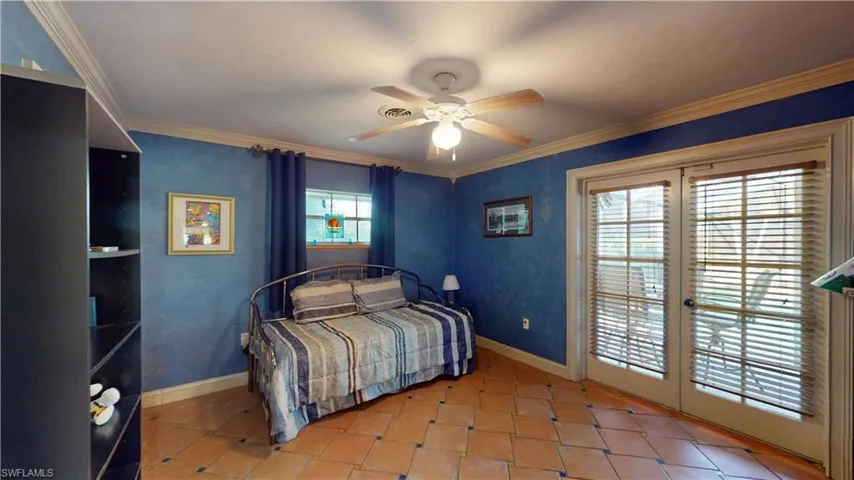 Bedroom with access to outside, ornamental molding, ceiling fan, french doors, and light tile patterned floors