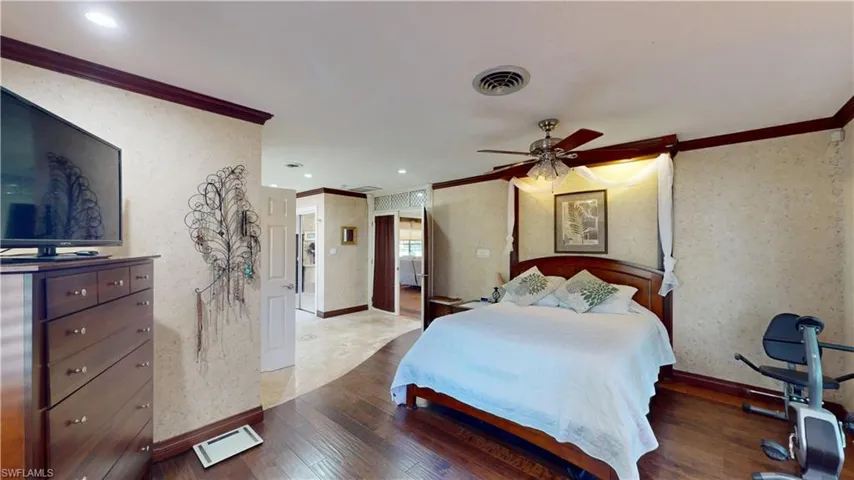 Bedroom featuring wallpapered walls, ornamental molding, hardwood / wood-style floors, recessed lighting, and a ceiling fan