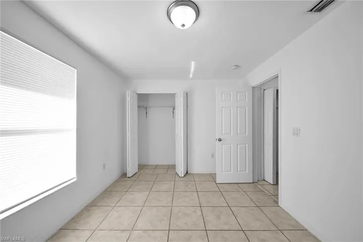 Neutral-toned tile flooring throughout