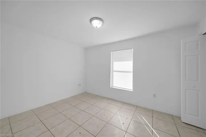 Bright interior space featuring light-colored tile flooring