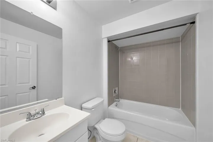 Bathroom featuring a vanity with an integrated sink, polished chrome faucet, and overhead lighting