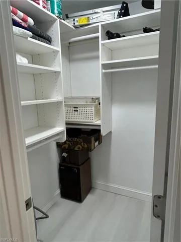 Spacious closet featuring light wood-type flooring