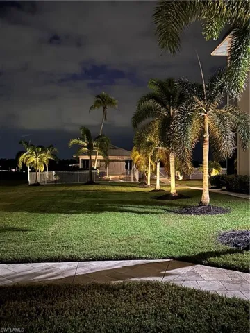 View of property's community with a yard