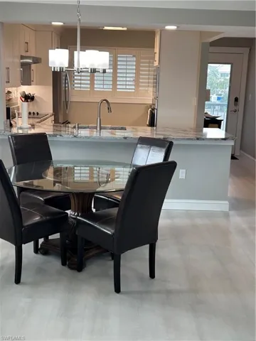 Dining room featuring a notable chandelier and sink