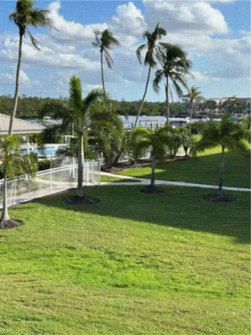View of home's community featuring a water view and a yard