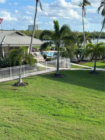 View of home's community featuring a yard and a swimming pool