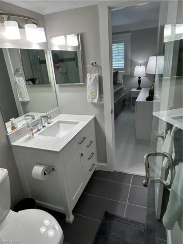 Bathroom featuring tile patterned floors, vanity, and toilet